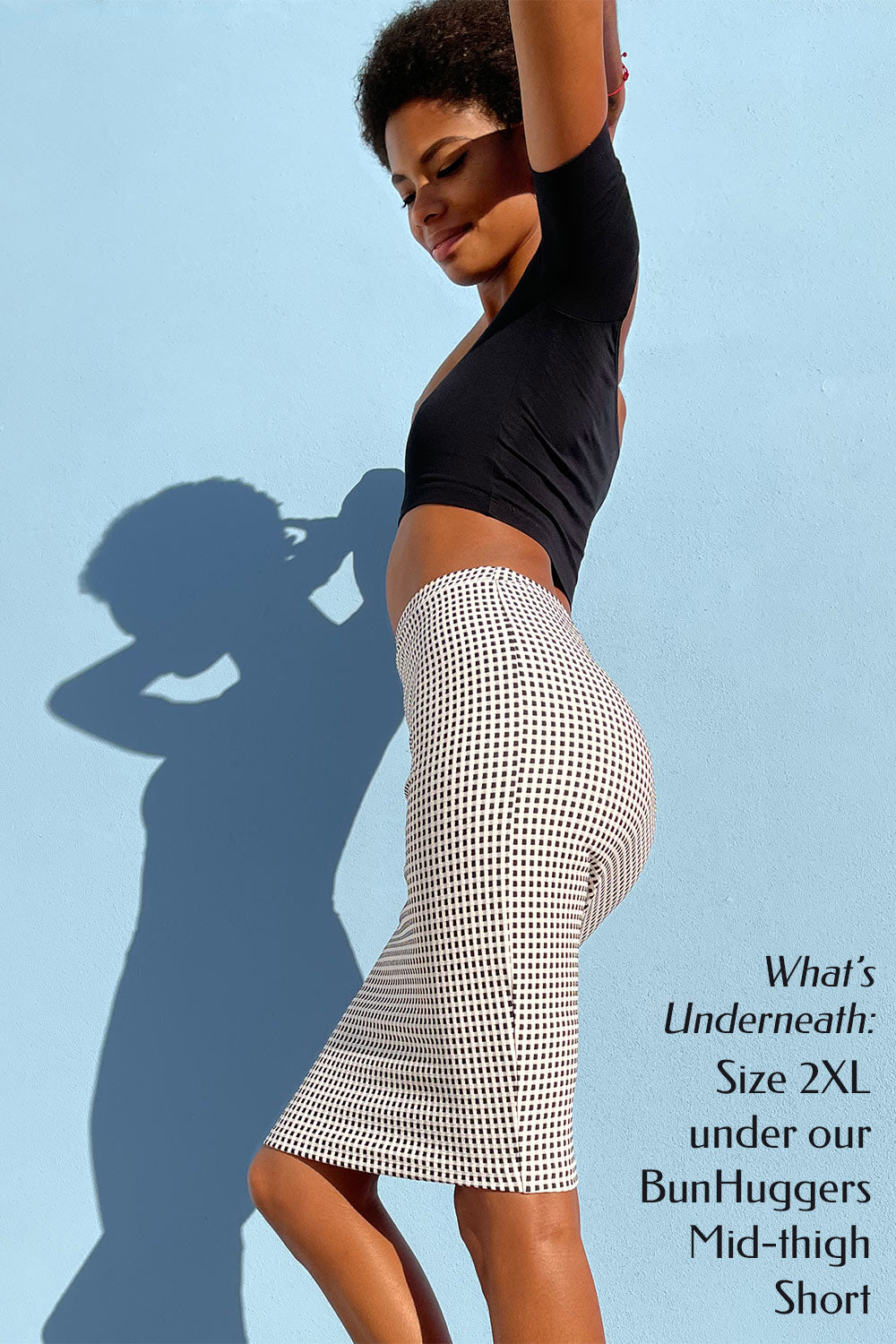 Model wearing mid-thigh short showcasing Adhesive Butt Pads under a fitted skirt.