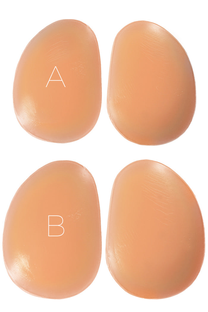 Oblong-shaped silicone butt pads showing size A and size B next to eachother.