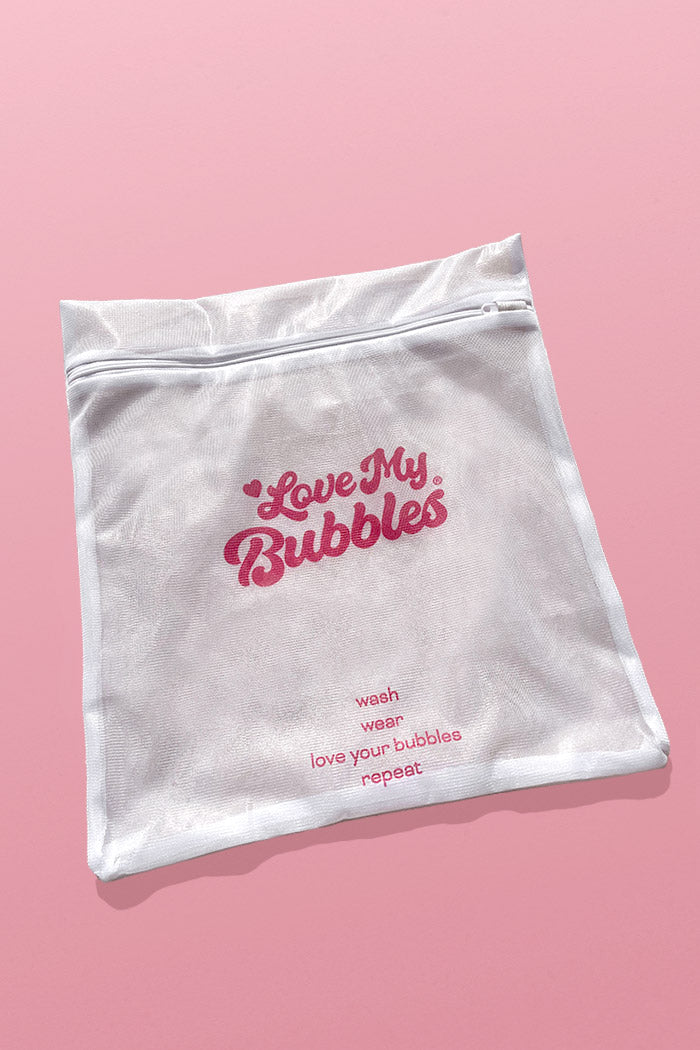 Love My Bubbles laundry bag featuring care instructions for washing garments.