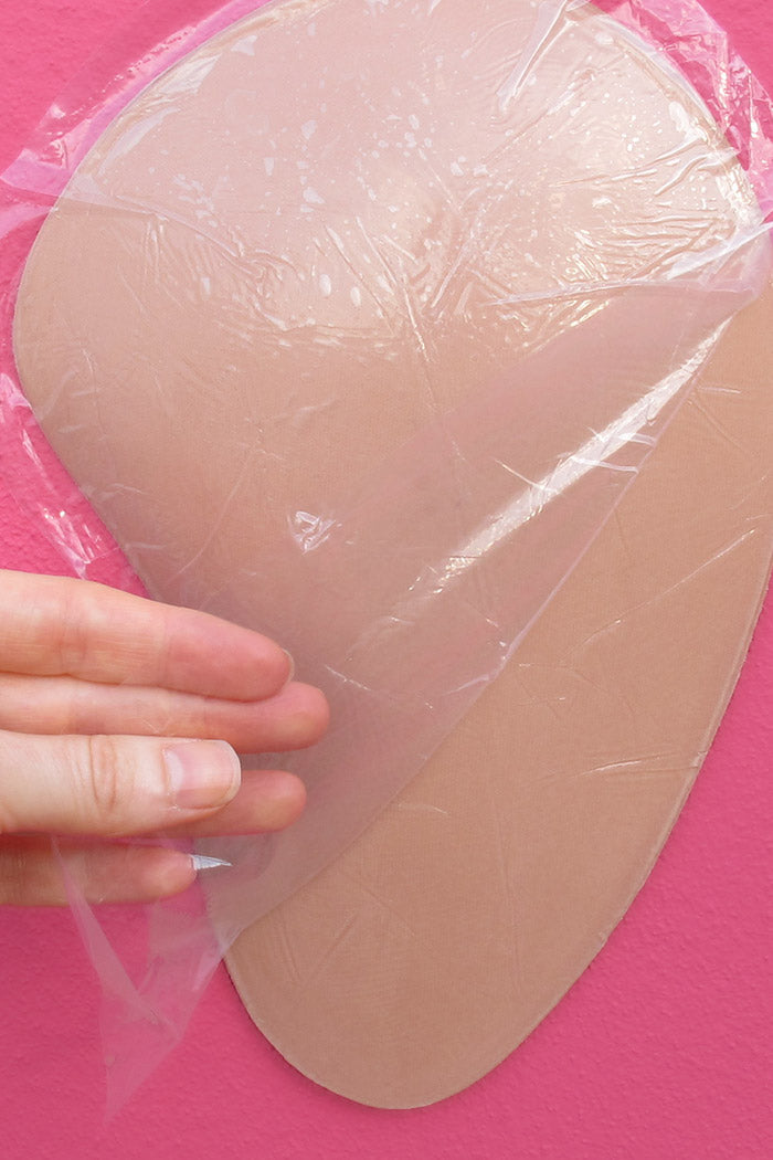 Sticky Hips Foam Hip Pads Self-Adhesive Foam Hip Pads being unwrapped from protective layer.