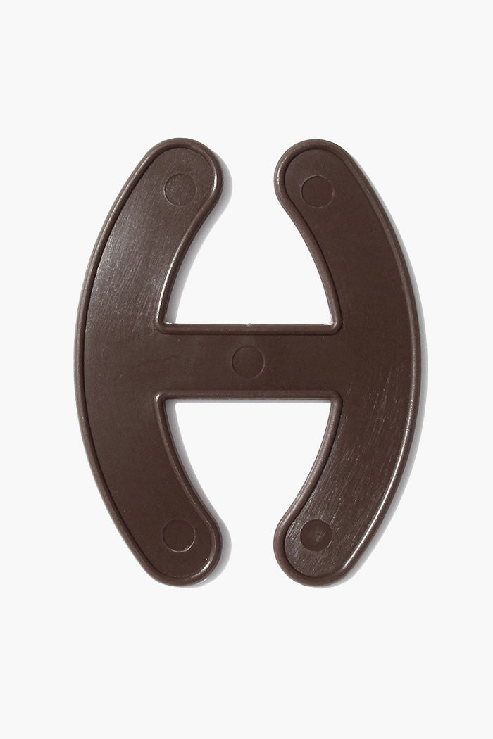 The Strapper Bra Strap Adjuster in dark brown color, designed to prevent visible bra straps and enhance comfort.